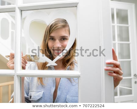 Stock foto: Woman Painting A Heart On The Window