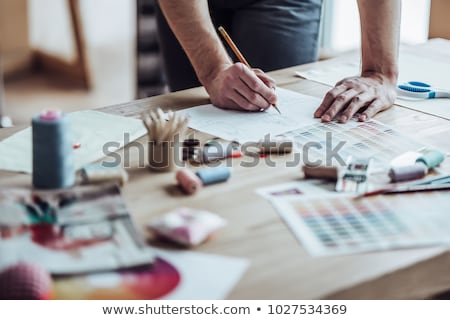 [[stock_photo]]: Man Cuts Textile With Scissors