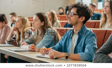 Zdjęcia stock: Group Of Students With Notebooks At Lecture Hall