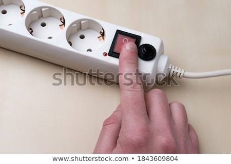 Stock fotó: Man With His Finger In A Light Socket