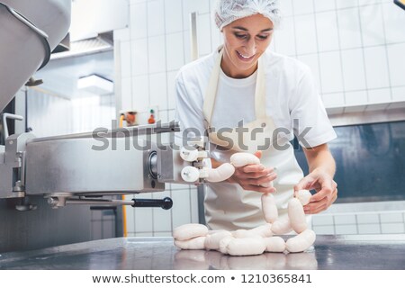 Female Butcher Making Sausages Foto stock © Kzenon