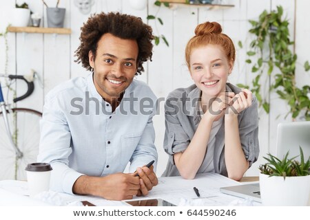 Foto stock: Male And Female Workers With Technical Blueprints And Computer T