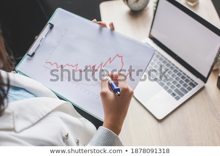 Stock photo: Woman Pointing To Clip Board With Pen