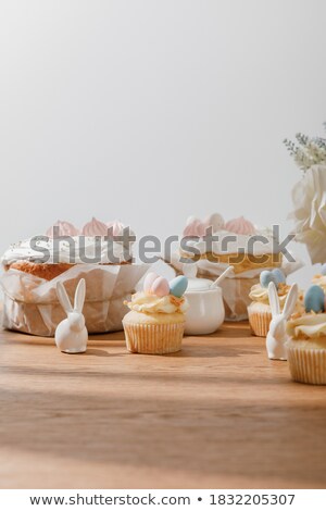 Foto stock: Painted Easter Eggs And Delicious Cupcake On White Isolated Back