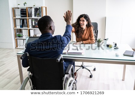 Stock foto: Disabled Businessman Giving High Five To His Partners