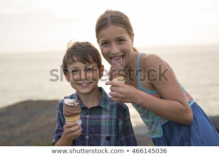 Brother And Sister Eating A Delicious Ice Cream On The Sunset Foto d'archivio © Lopolo