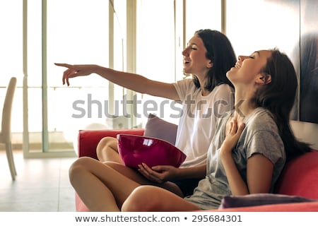 Foto stock: Portrait Of Laughing Caucasian Couple Watching Tv And Eating Popcorn