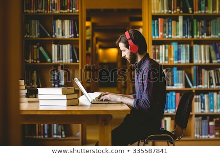 商業照片: Hipster Student Studying In Library At University