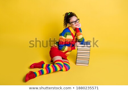 [[stock_photo]]: Young Clever Student Sitting On The Floor With High Stack Of Books