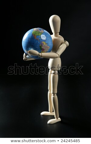 Drewniany mały manekin trzyma mapę świata Zdjęcia stock © lunamarina