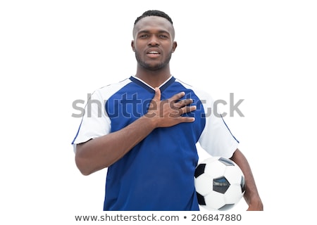 Foto stock: Football Player In Blue Standing With The Ball Listening To Anth