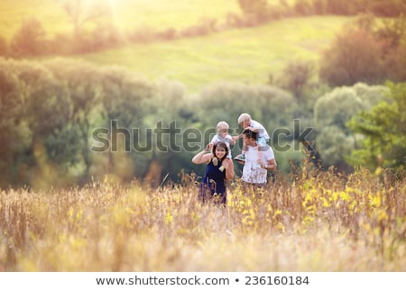 Stockfoto: Enjoying Childhood At Summer Vacation Walking On Grass Meadow