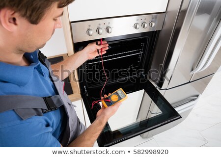 Foto stock: Technician Repairing Oven