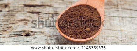 Stock fotó: Carob Powder In A Wooden Spoon On An Old Wooden Background