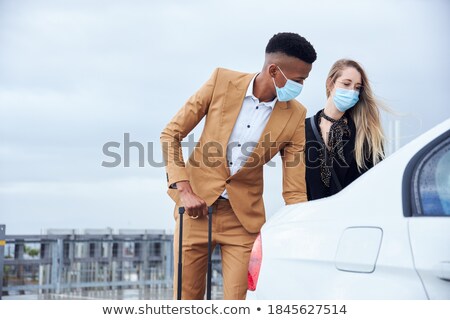 Foto d'archivio: Women With Luggage Getting Into Taxi Car