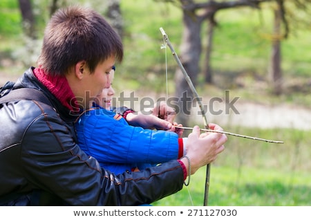 ストックフォト: A Father Teaching His Son How To Shoot A Bow