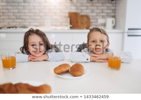 Stock fotó: Smiling Dark Haired Woman Having A Coffee In Her Kitchen