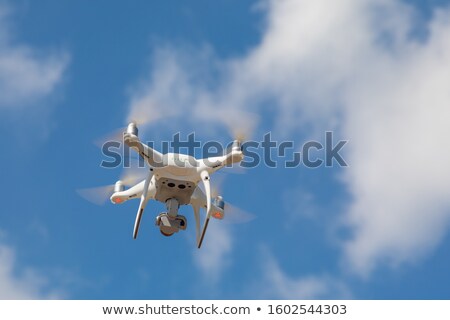 Zdjęcia stock: Drone Quadcopter From Below Against A Blue Sky