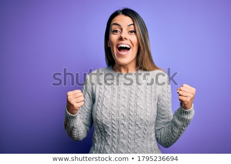Stok fotoğraf: Cheerful Young Woman Wearing Sweater Standing