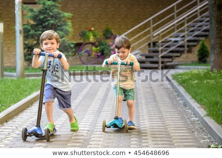 ストックフォト: Boy Riding Scooters Outdoor In The Park Summertime Kids Are Happy Playing Outdoors Banner Long F