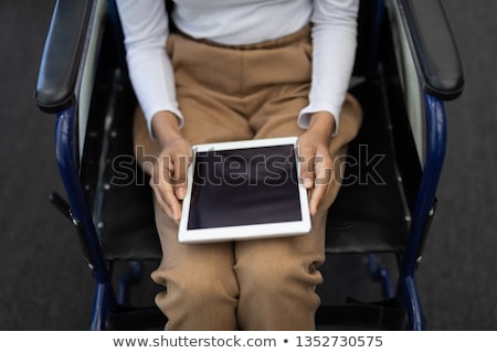 Stock photo: Mid Section Of Young Disabled Mixed Race Businesswoman Working On Computer At Desk In The Office