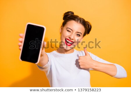 Сток-фото: Cheerful Woman Showing Her Smartphone