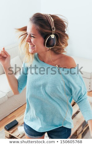 Foto stock: Girl Listening To Music In Her House Dancing