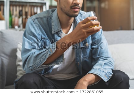 Foto d'archivio: Close Up Of Drunk Man Drinking Alcohol At Night