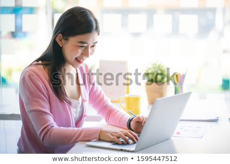 ストックフォト: Attractive Young Beautiful Asian Woman Working With Laptop And D