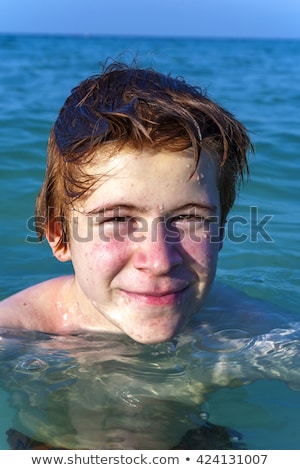 Foto stock: Young Boy With Red Hair Is Enjoying The Beautiful Beach