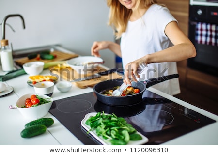 Foto stock: Young Woman At Home Preparing Food