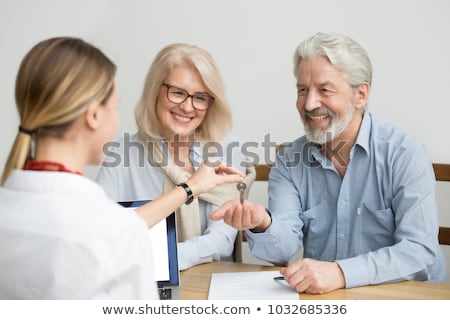 Foto stock: Realtor Giving Key To Customer At New Office