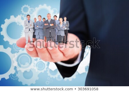 Stock fotó: Business Man Standing Against People In Cogs Graphics Against Grey Background