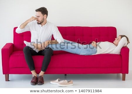 Foto stock: Loving Couple Lying Down On The Sofa In The Room