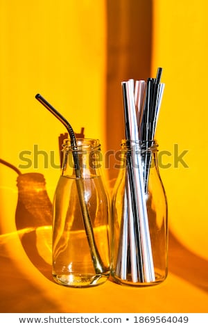 Foto stock: Steel Drinking Vs Disposable Straws On A Yellow Background Zero Waste Concept