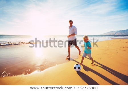 Foto stock: Happy Family Father Two Kids Playing Football On Beach Summer
