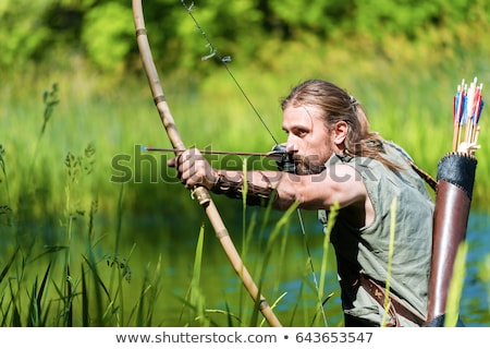 Foto stock: A Male Bow Hunter In A Forest