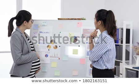 Stok fotoğraf: Business Woman Thinking Pregnancy Plans
