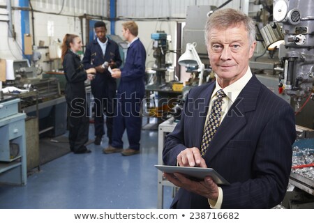 Stock photo: Portrait Of Engineer Using Drill In Factory