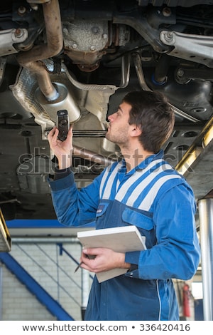 Stock photo: Mechanic Underneath A Car During A Periodic Examination