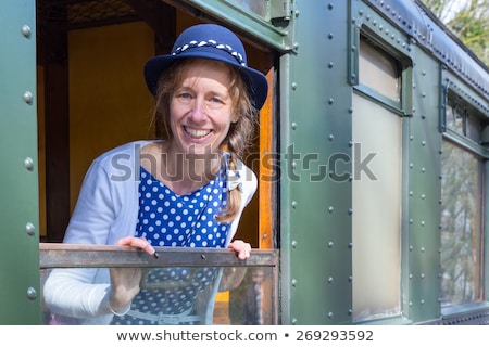 [[stock_photo]]: Dutch Woman In Old Fashioned Clothes In Window Of Steam Train