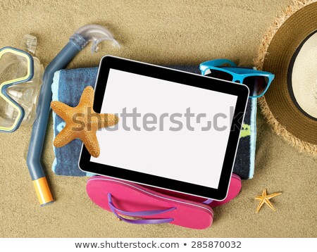 Foto stock: Tablet And Beach Accesories On Sand