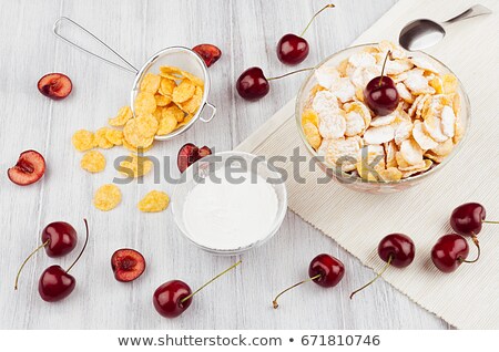 Сток-фото: Soft Light Breakfast With Golden Corn Flakes Ripe Cherries Powdered Sugar On White Wood Board Top