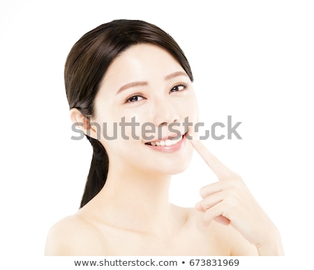 Stok fotoğraf: Close Up Portrait Of Happy Young Asian Girl Pointing With Finger