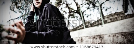 Stock foto: Portrait Of Anxious Teenage Girl Leaning On Wire Mesh Fence At School Campus