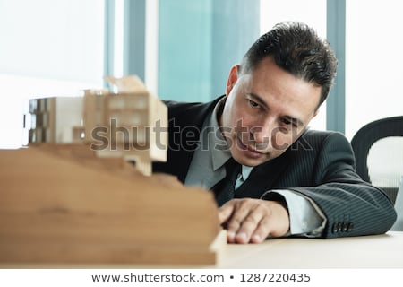 Stock photo: Confident Businessman Looking At Architecture Miniature House Project