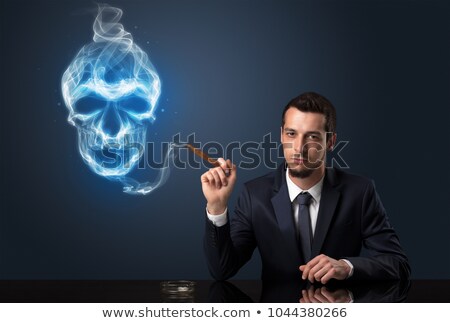 Stok fotoğraf: Handsome Young Business Man Holding A Cigarette