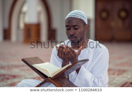 Stock photo: Muslim Man In Dishdasha Praying At Mosque