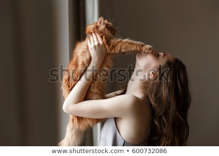 Stock photo: Young Woman In Nightie Playing With Cat