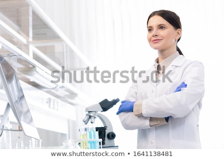 Foto stock: Scientist Wear Lab Coat And Protective Wear Are Working With Res